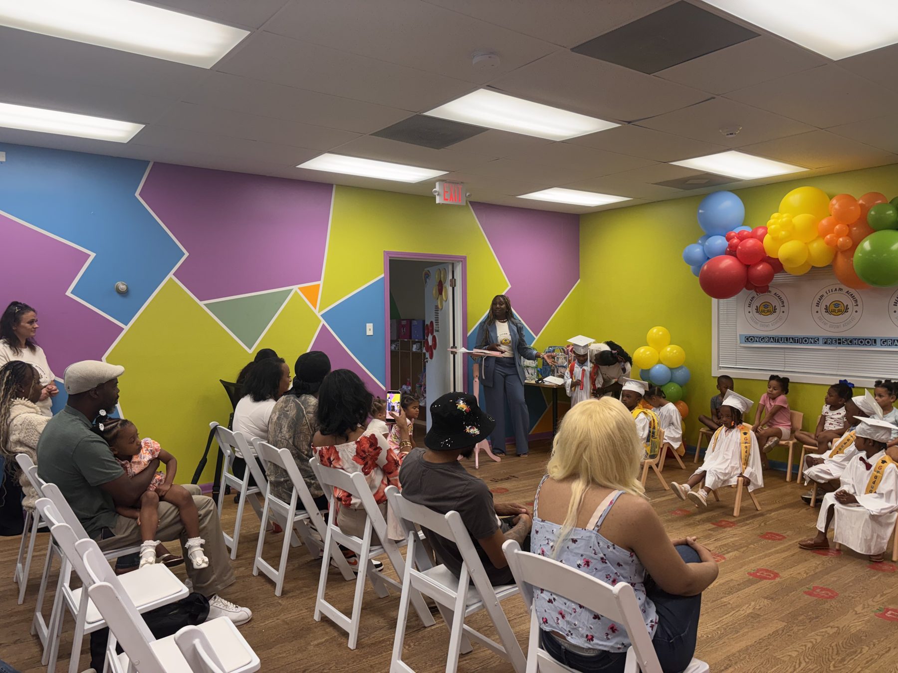 Families watching the Dream STEAM Academy pre-school graduation ceremony